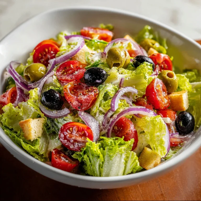 olive garden salad on a plate with garnish